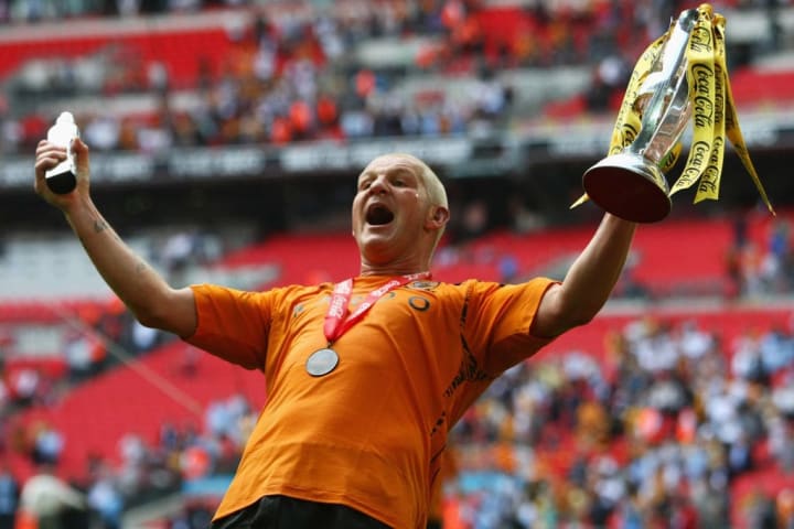 Dean Windass lifts the play-off trophy in front of the Hull fans